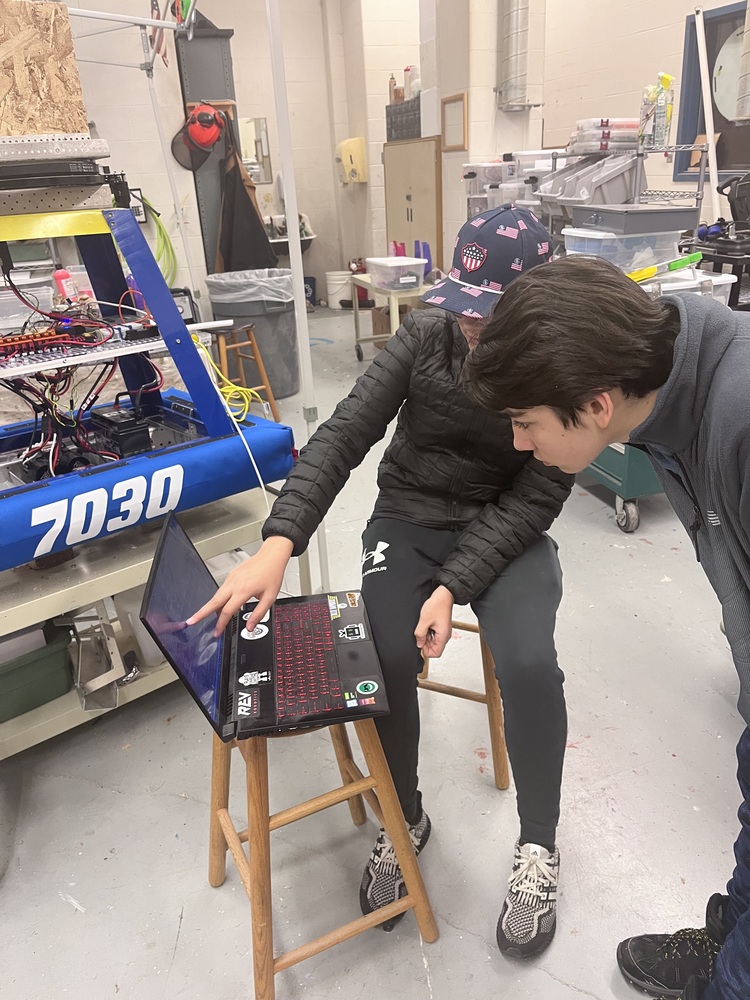 ​Caleb showing Gabriel our robot code